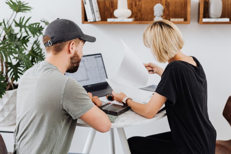 Small-business owner and technology consultant reviewing IT support options
