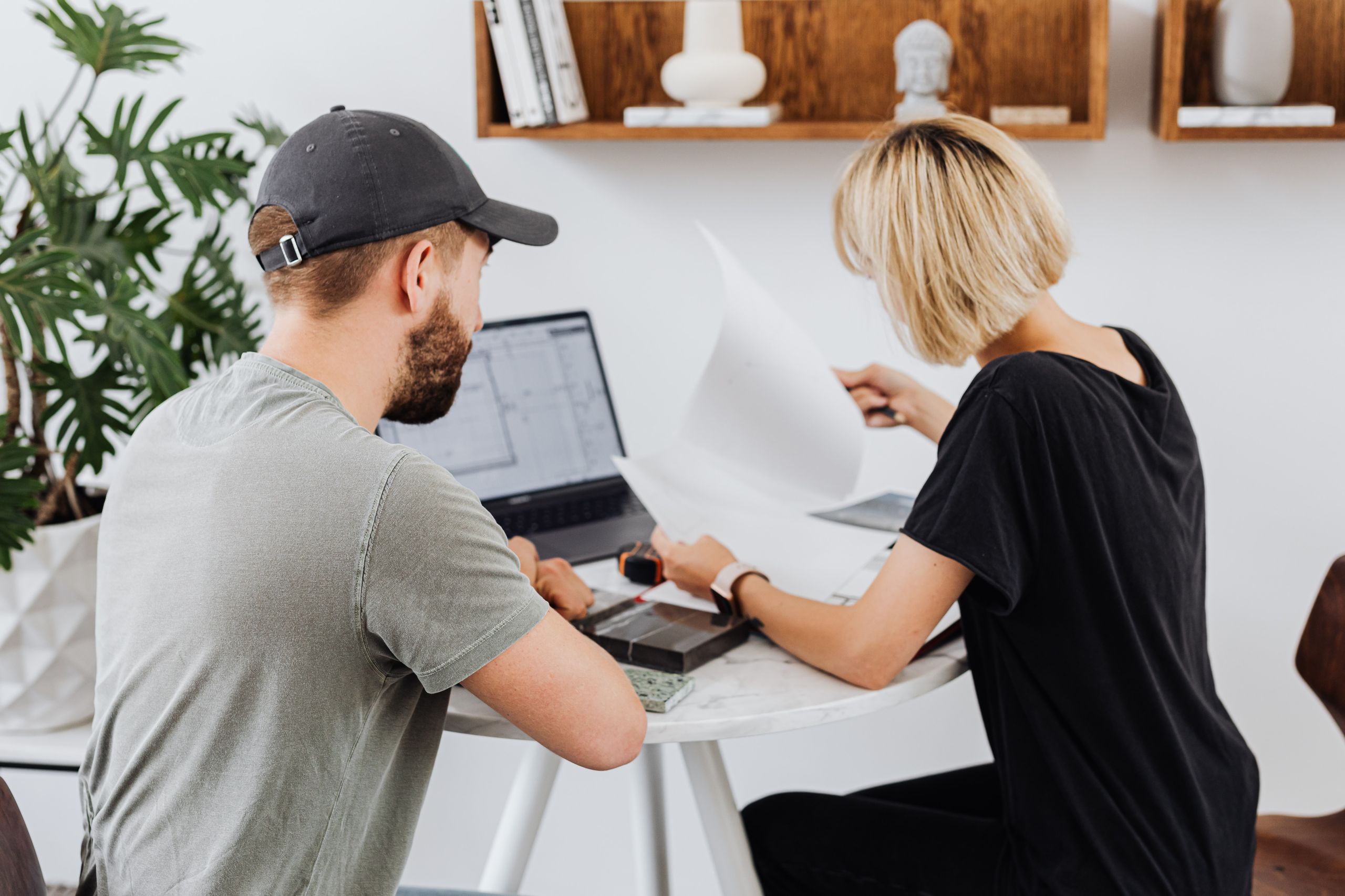Small-business owner and technology consultant reviewing IT support options